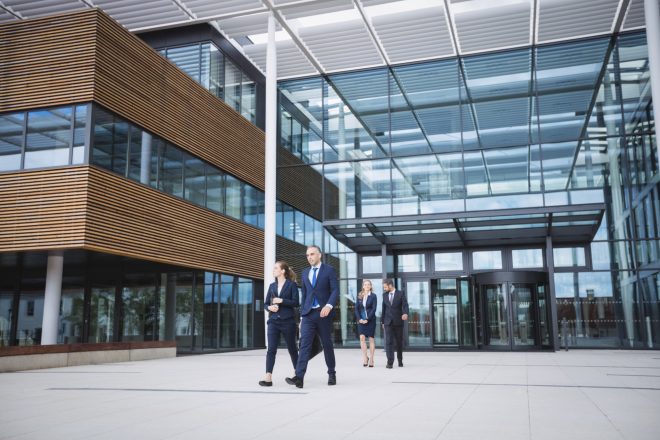 Business people walking outside an office building