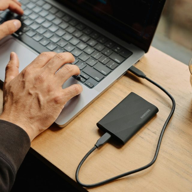 person sitting at a table using computer