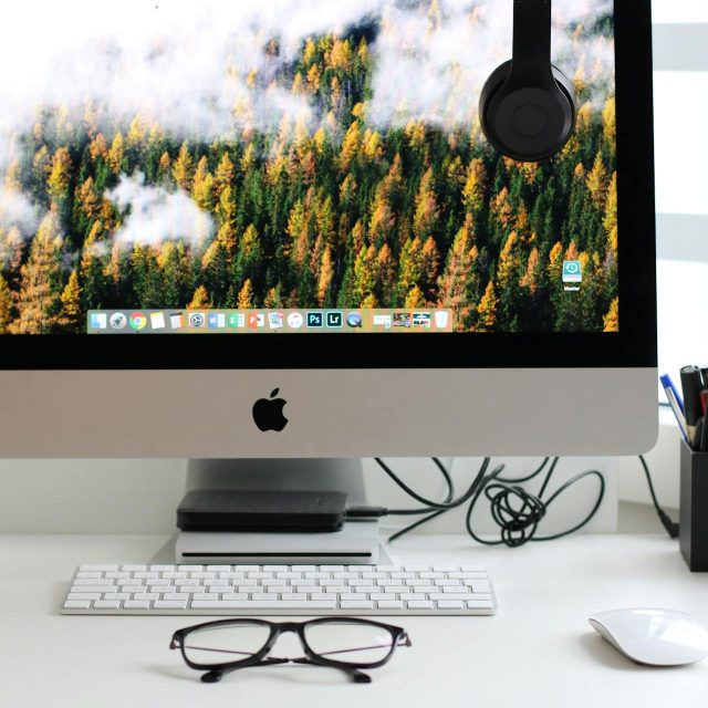 desktop computer home screen with headphones and glass surrounding