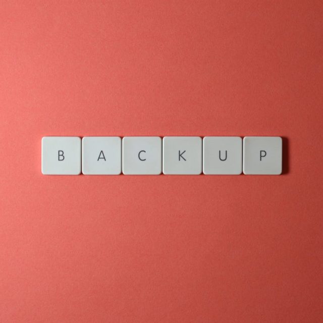 backup spelled across red background