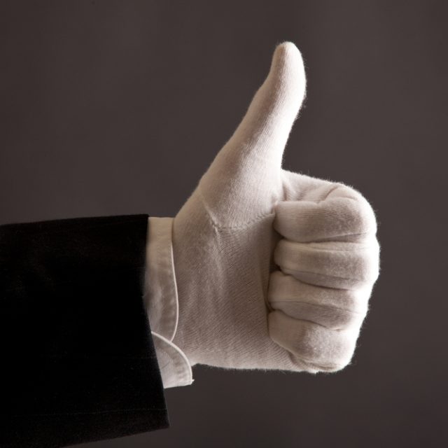 white gloved hand giving thumbs up