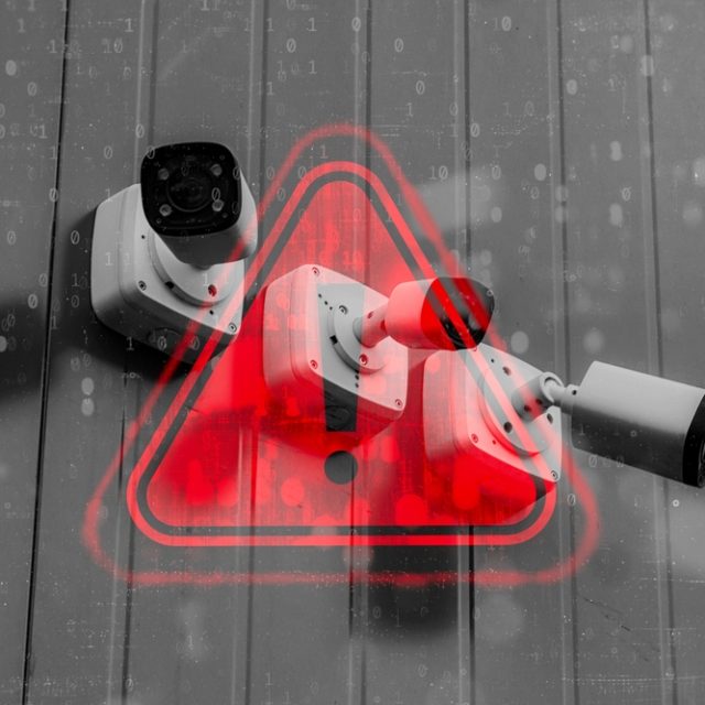 cameras mounted to a building with red warning symbol overlayed